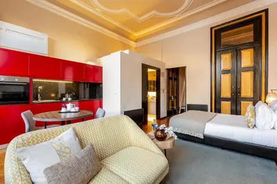 a bedroom with a bed and a couch and a table at YOUROPO - Bolhao in Porto