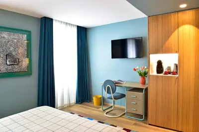 a bedroom with a bed and a table and chairs at The Editory House Ribeira Porto Hotel in Porto