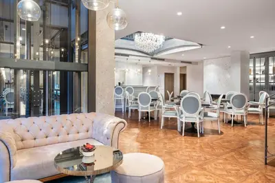a lobby with a couch and a table and chairs at Eurostars Porto Douro in Porto