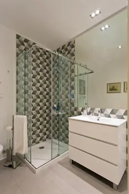 a bathroom with a shower with a sink and a shower at Oporto Golden View Ribeira in Porto