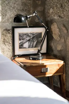 a desk with a lamp and a picture on it at Downtown Residence by Apartments2Enjoy in Porto