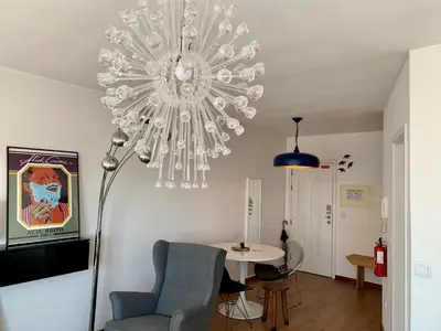 a chandelier in a living room with a chair and a table at Downtown Residence by Apartments2Enjoy in Porto