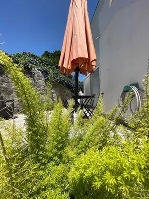 a closed umbrella sitting next to a building at Burgães II Apartment in Porto