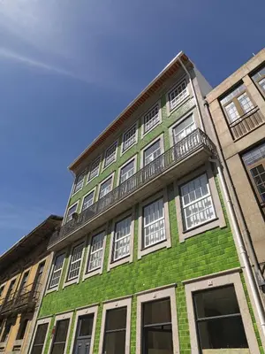 a green and white building with white windows at FLH Porto Modern Rooftop in Porto