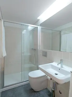 a bathroom with a shower and a toilet and a sink at FLH Porto Modern Rooftop in Porto