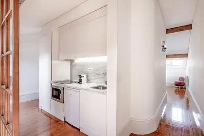 a kitchen with white cabinets and a sink at VIVA Almada Flats in Porto