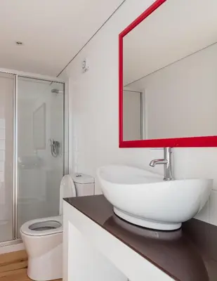 a bathroom with a sink and a toilet and a mirror at VIVA Almada Flats in Porto