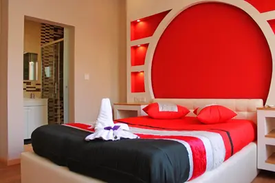 a bedroom with a large bed with a red headboard at Monte Carlo Love Porto in Porto