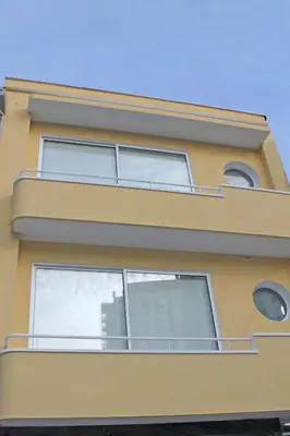 a yellow building with windows and a balcony at Monte Carlo Love Porto in Porto