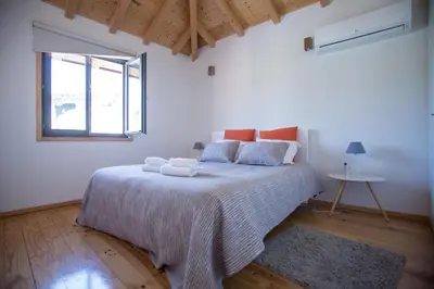 a white bedroom with a large bed with towels on it at LivingPorto Apartments by Porto City Hosts in Porto