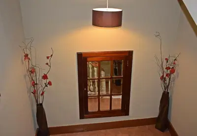 a room with a window and two vases with flowers at GuestHouse Belo Horizonte in Porto