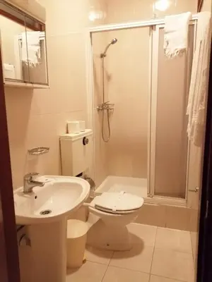 a bathroom with a sink and a toilet and a shower at Residencia Vale Formoso in Porto