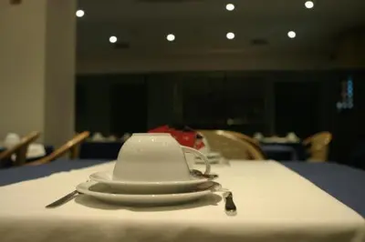 a stack of white plates sitting on a table at Hotel Douro in Porto