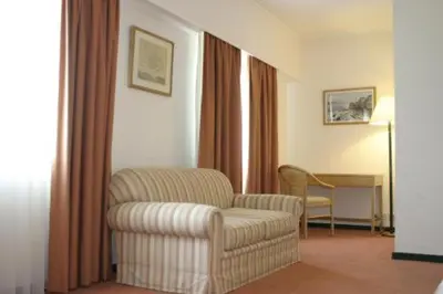 a living room with a chair and a table at Hotel Douro in Porto