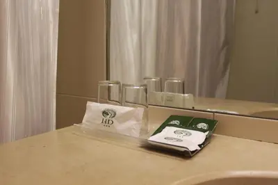 a bathroom with a counter with towels and a mirror at Hotel Douro in Porto