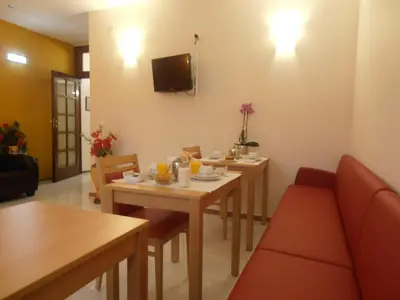 a living room with two tables and a couch at Hotel S. Marino in Porto