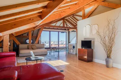 a living room with a couch and a tv at Oporto Maison Alves da Veiga in Porto