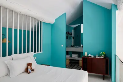 a bedroom with blue walls and a bed with a teddy bear on it at Cocorico Luxury House - Porto in Porto