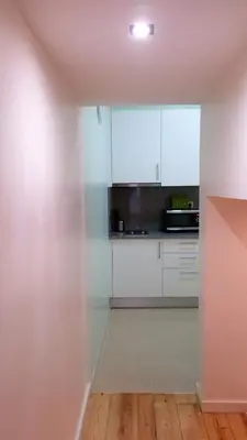 a kitchen with white cabinets and a counter top at D&S - Crocodile House S. Bento Apartments in Porto