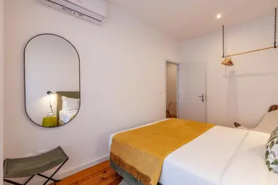 a bedroom with a large bed and a mirror at D&S - Crocodile House S. Bento Apartments in Porto