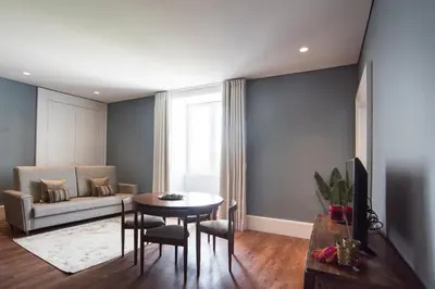 a living room with a table and a couch at bnapartments Carregal in Porto