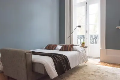 a bedroom with a bed and a window at bnapartments Carregal in Porto