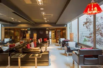 a lobby with couches and chairs in a store at Porto Trindade Hotel in Porto