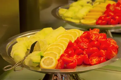 a tray of fruits and vegetables on a table at Porto Trindade Hotel in Porto