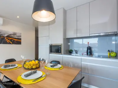 a kitchen with a table with a bowl of fruit on it at Passos Manuel by Innapartments in Porto