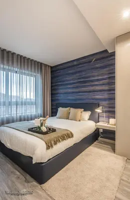 a bedroom with a large bed and a large window at Passos Manuel by Innapartments in Porto