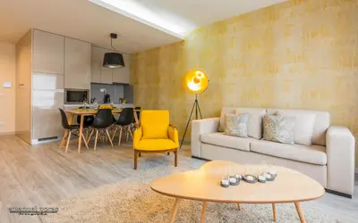 a living room with a couch and a table at Passos Manuel by Innapartments in Porto