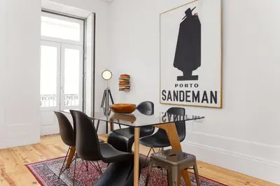 a dining room with a table and black chairs at Oporto Chic & Cozy - Bolhão in Porto