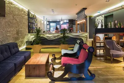 a living room with two chairs and a table at Nice Way Porto Hostel in Porto
