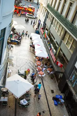 an overhead view of a street with tables and umbrellas at Nice Way Porto Hostel in Porto