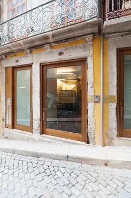 a store front with glass doors on a building at Go2Oporto - Historical Center in Porto