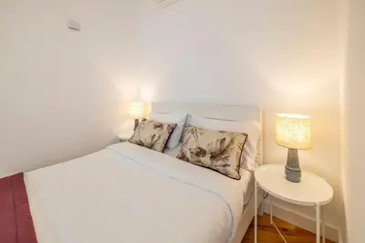 a bedroom with a bed and a lamp on a table at Try Oporto - São Lázaro in Porto