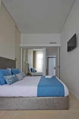 a bedroom with a large bed with blue pillows at OHH -Porto 4 you- Deluxe Apartment With Free Parking in Porto