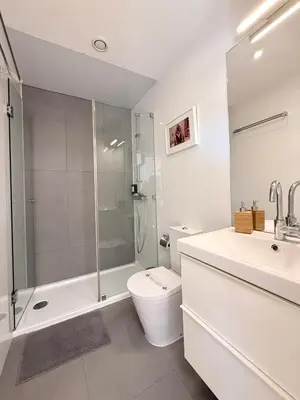 a bathroom with a shower and a toilet and a sink at Porto Cinema Apartments in Porto