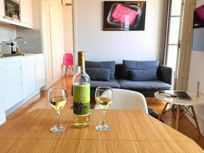 a bottle of wine and two glasses on a table at Porto Cinema Apartments in Porto