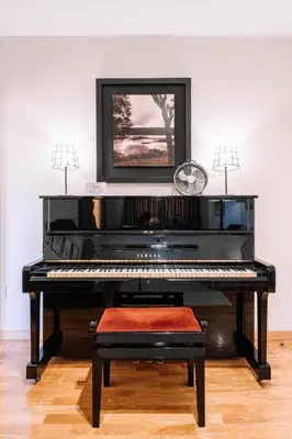 a piano in a room with a picture on the wall at BBA Apartments Boavista - Casa da Música with free parking in Porto