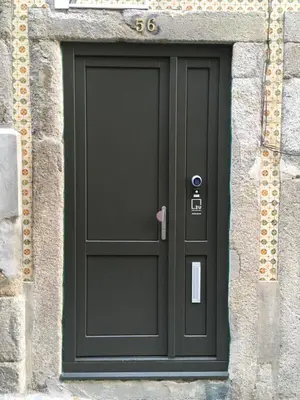 a black door in a stone building with the number six at 2U Oporto Urban Stays in Porto