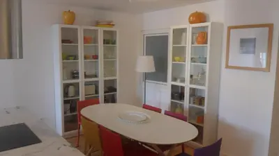 a dining room with a table and some glass cabinets at SBV Perfect River View in Porto