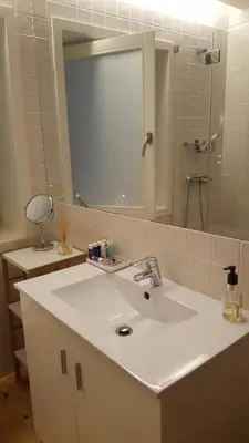 a bathroom with a white sink and a mirror at SBV Perfect River View in Porto