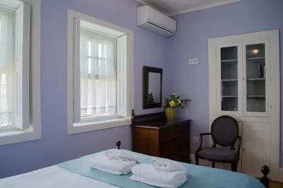 a blue bedroom with a bed with towels on it at Porto.arte guest apartments in Porto