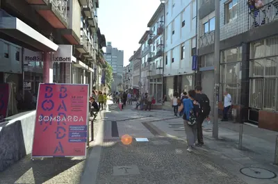 a group of people walking down a city street at Porto.arte guest apartments in Porto