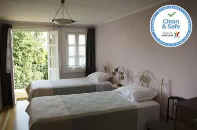two beds in a room with a sign that says clean and safe at Porto.arte guest apartments in Porto