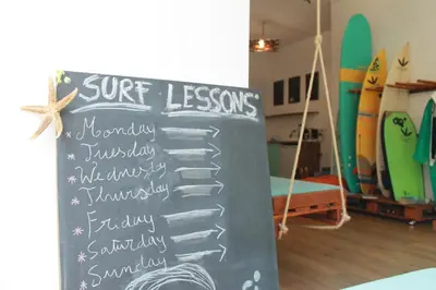 a man riding a wave on a surfboard in the ocean at Douro Surf Hostel in Vila Nova de Gaia