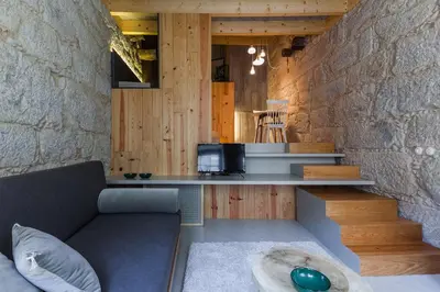 a living room with a couch and a tv at Armazém Luxury Housing- Architectural & Design Hotel in Porto
