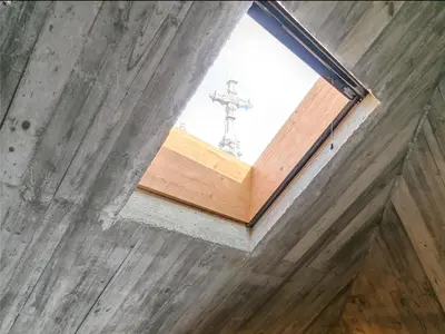 a window in a room with a cross in the background at Armazém Luxury Housing- Architectural & Design Hotel in Porto