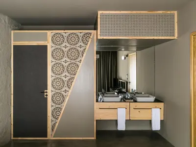 a bathroom with two sinks and a large mirror at Armazém Luxury Housing- Architectural & Design Hotel in Porto